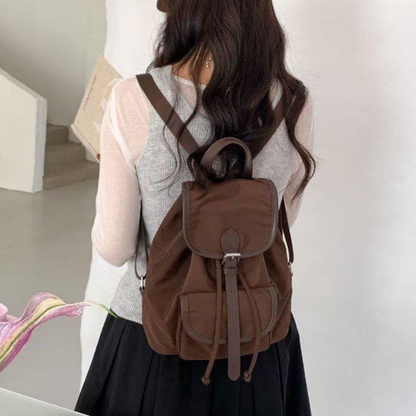 Lightweight Drawstring Flap Mini Backpack With Front Slip Pocket, Metal Slider Buckle Fastener And Integrated Top Carry Grip